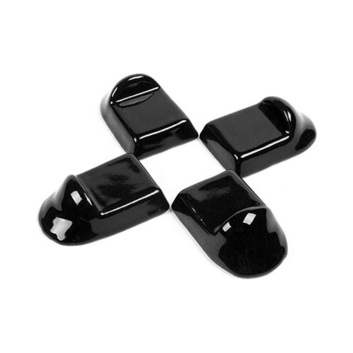 Four black ceramic knobs on a white background